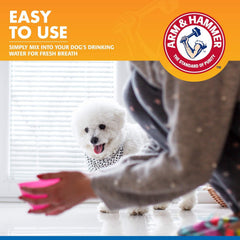 Dog drinks water with Arm & Hammer dental rinse for ongoing oral care.