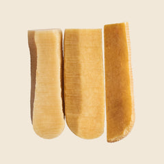 WAG Yak Cheese chew demonstrating plaque scraping action for oral care.